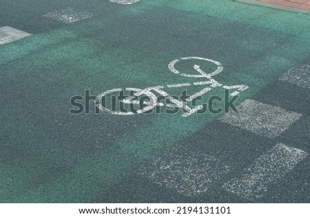 Cycle path with a drawn bicycle. Bike lane sign at a pedestrian crossing