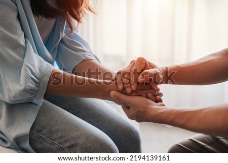 Young man comforting and supporting a sad woman who is in serious trouble at home, Consolation and encouragement concept Royalty-Free Stock Photo #2194139161