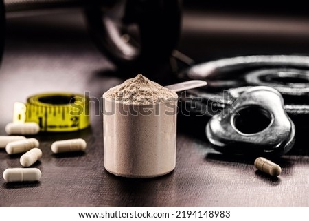 Measuring Spoon with Creatine or Whey, Food Supplement, Casein Cocktail, Muscle Mass Vitamin, Plated, Bodybuilding Concept Royalty-Free Stock Photo #2194148983
