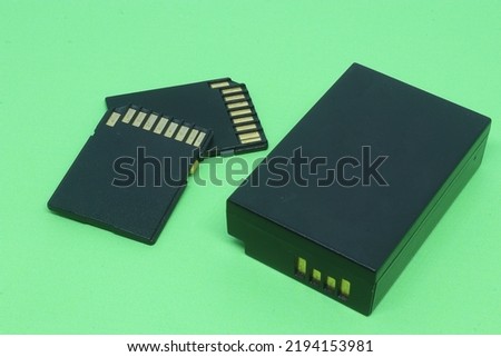 two large memory cards with a DSLR camera battery Royalty-Free Stock Photo #2194153981