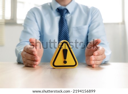 Warning sign in businessman's hand, Caution in investing Economic situation warning, Deflation and  inflation concept. Royalty-Free Stock Photo #2194156899