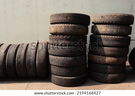 a collection of used truck tires that have been damaged and are being dried in the sun
