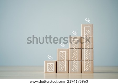 Interest rate finance and mortgage rates concept. Wooden blocks with growth of bar chart percentage sign, financial growth, interest rate increase, inflation, sale price and tax rise concept. Royalty-Free Stock Photo #2194175963