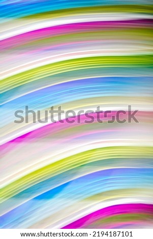 Defocused multicolored belt creating wave patterns .Multi-colored abstract blurred background of all colors of the rainbow.Striped blurred gradient.