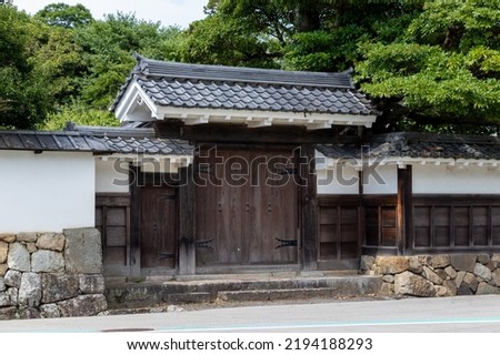 An old-fashioned wooden gate with a tiled roof Royalty-Free Stock Photo #2194188293