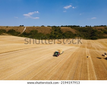 Agricultural Farms and Working Machines at Dunstable Downs England. High Angle Footage taken with drone's camera on a hot summer day of England