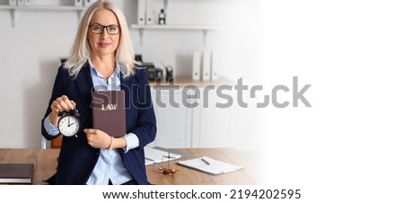 Mature female judge with alarm clock and law book in office. Banner for design