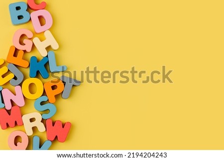 Colorful letters of the alphabet on yellow background. Primary school or preschool, kindergarten. Educational game. Learning through play. 