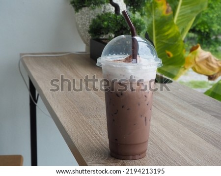 Delicious iced cocoa on a wooden table at the cafe