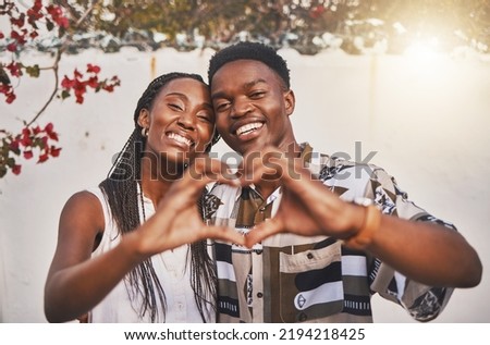 Happy couple heart love sign with their hands posing for a picture or photo while on vacation or holiday. Portrait of a loving and young African American lovers having fun together smiling in joy Royalty-Free Stock Photo #2194218425