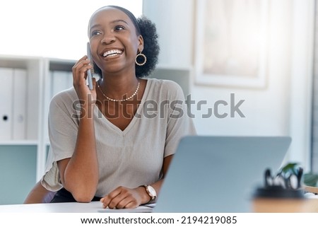 Happy business woman smile talking on phone call or young entrepreneur answering cellphone while sitting in front of work laptop in an office. Female executive smiling and laughing at a funny joke Royalty-Free Stock Photo #2194219085