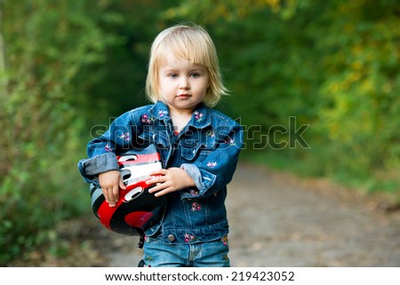 Beautiful little girl with sport helmet for bicycle, roller or skate
