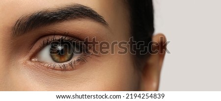 Closeup view of woman with beautiful eyes on white background. Banner design