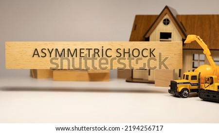 asymmetric shock was written on the wooden surface. Economy and concept.