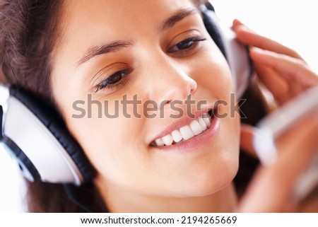 Happy girl, headphones and streaming music or podcast to relax in free time on the weekend. Beautiful and cute teen listening to audio playlist on smartphone with headset for study break.