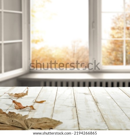 Desk of free space for your decoration and autumn window background. 