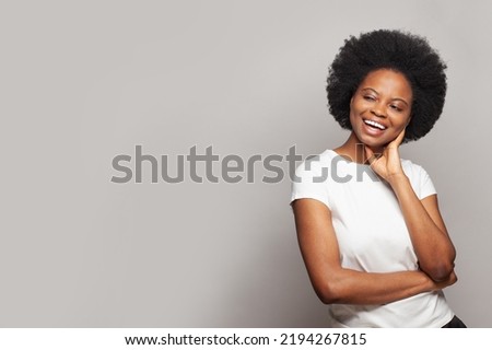Pretty excited young woman looking at copy space against white studio wall banner background
