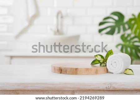 Podium for product display and towel on blurred bathroom background Royalty-Free Stock Photo #2194269289