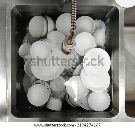 Top view many dirty dishes in kitchen sink Royalty-Free Stock Photo #2194274167