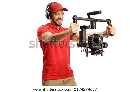 Camera operator recording with a camera gimbal stabilizer isolated on white background Royalty-Free Stock Photo #2194274639