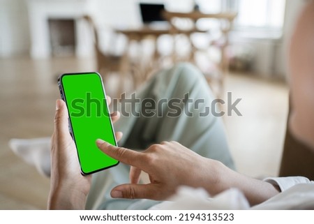 Green screen a woman uses a phone in her hand taps on the screen