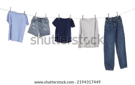 Different clothes drying on washing line against white background Royalty-Free Stock Photo #2194317449