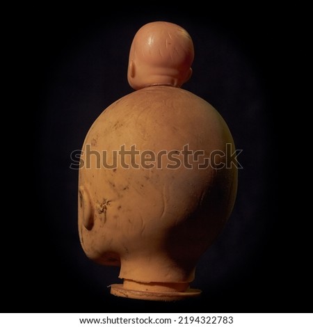Damaged Dirty Doll head on black background isolated