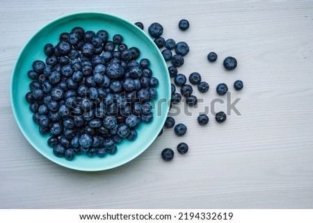 Fresh Blueberries blueberry BowlTable Freshly picked turquoise bowl. Juicy and fresh blueberries Bilberry white wood food Background. antioxidant. Concept healthy eating nutrition fruit  top view.