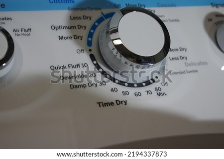 Clothes dryer control switch in off position Royalty-Free Stock Photo #2194337873