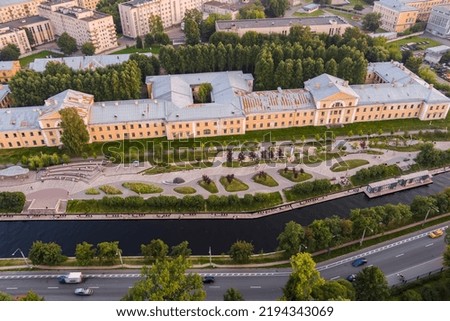 Aerial view of the public park of the Karpovka River Embankment in St. Petersburg at sunset, Russia, recreation areas, benches and amphitheater, botanical garden opposite the park