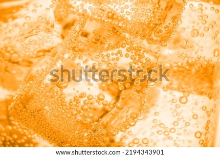 Closeup view of soda water with ice. Toned in orange Royalty-Free Stock Photo #2194343901