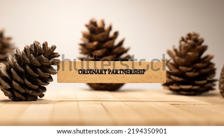 Ordinary partnership written on wooden surface. European economy and politics