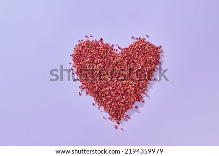 Red rose petals shaped as heart.