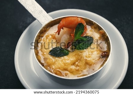 Julienne with shrimps on a dark background, selective focus, artistic processing