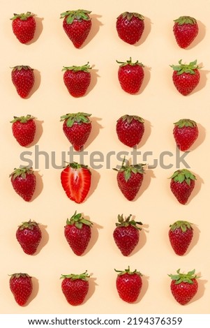 Fresh red strawberry isolated on peach background, top view. Minimalistic strawberry pattern. Flat lay, copy space