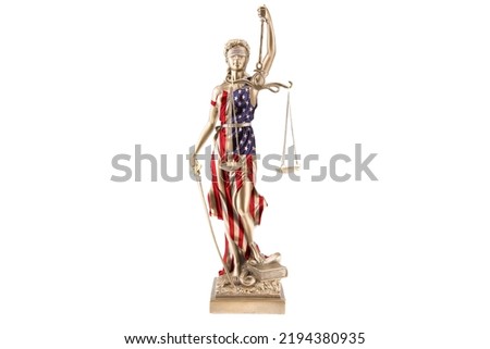 A statue of Justice wears the national flag of the USA as a dress. She steps on a snake and holds a scale in her hand. White background.