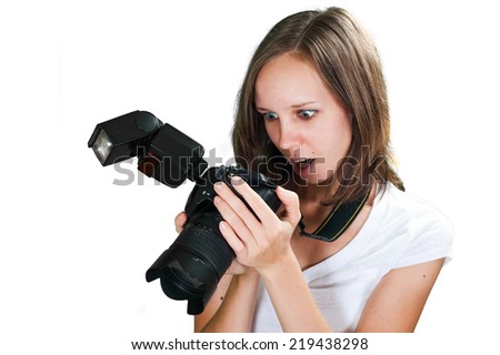 Funny picture of girl looking on camera screen isolated on white