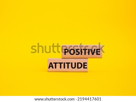 Positive attitude symbol. Concept words Positive attitude on wooden blocks. Beautiful yellow background. Business and Positive attitude concept. Copy space.