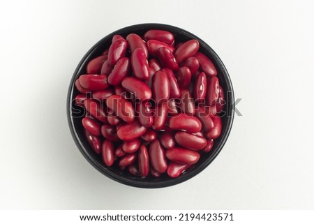 red kidney beans in a bowl on white background, top view, flat lay, top-down.