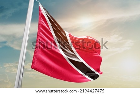 `Trinidad and Tobago national flag waving in beautiful clouds.