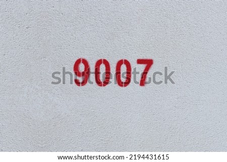Red Number 9007 on the white wall. Spray paint.
