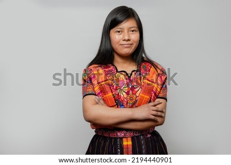 Portrait of Mayan woman with typical costume - Hispanic young woman with colorful traditional clothes on white background - Hispanic teenager Royalty-Free Stock Photo #2194440901
