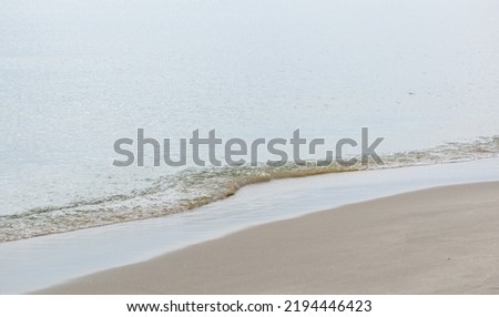 Background with Calm Ocean Waters Along Shoreline at the Beach Royalty-Free Stock Photo #2194446423