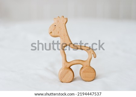 Eco friendly non plastic toys concept. Baby background. Wooden toy on white background with blank space for text.