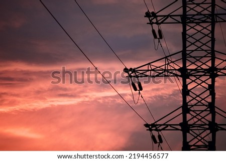 High voltage power lines pylons and electrical cables against the backdrop of a bright colorful sunset sky. Modern infrastructure of high voltage transmission lines. Overhead power lines. Electricity Royalty-Free Stock Photo #2194456577