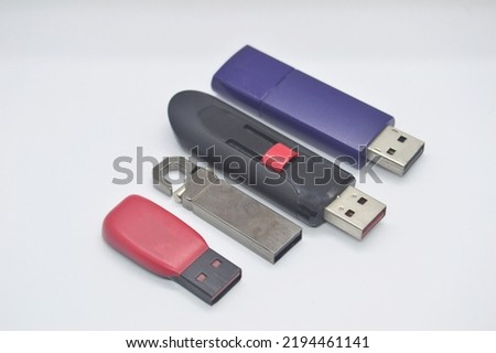 Flash drives, many shapes, old condition, placed on a white background.