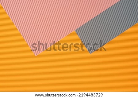 Gray, pink and orange three tone color paper background with stripes. Abstract background modern hipster futuristic. Texture design