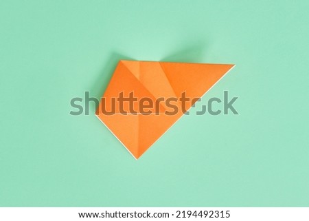 Origami Bear. Step-by-step photo instruction on a green background. DIY concept. Step5. 