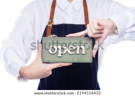 Owner person hold Open Sign Business to show service at door entrance store, cafe, retail and welcome shop. Happy Entrepreneur female wear waitress dress as open business time again concept