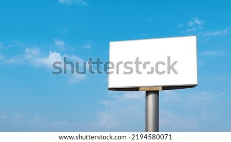 Blank billboard with empty screen over blue sky cloud background. For advertisement design or text. mockup template